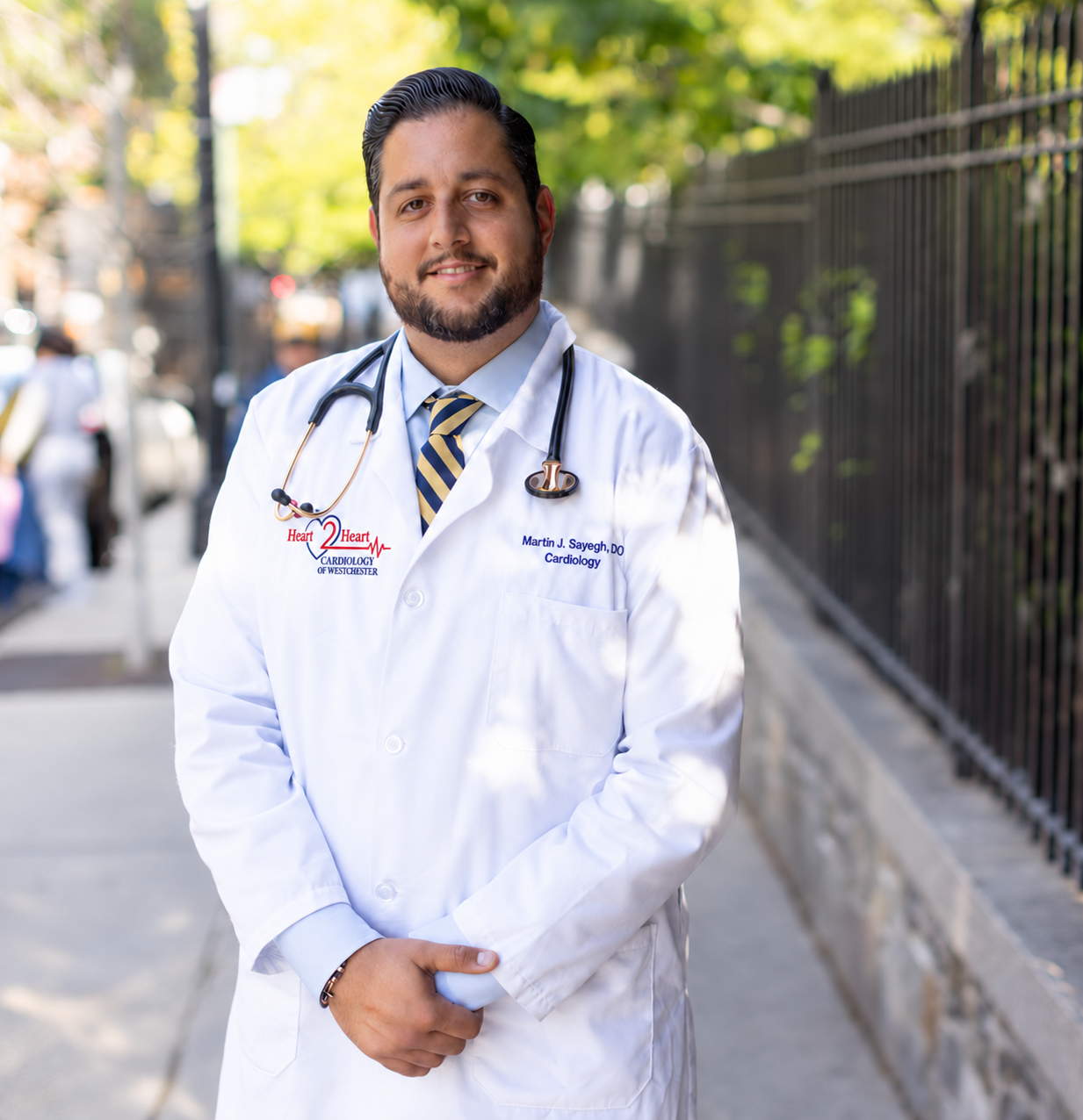 Dr. Martin Sayegh wearing a white physician’s coat